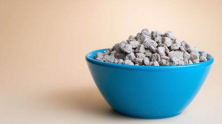Cement in a blue bowl on a beige background with copy spaceの素材