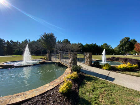 two fountains and a small pondの写真素材
