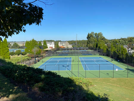 neat tennis courts and surrounding treesの写真素材