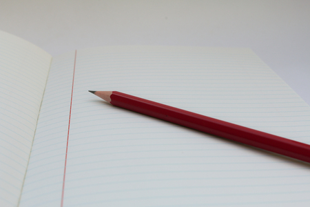 pencil on Note book isolated on white backgroundの写真素材