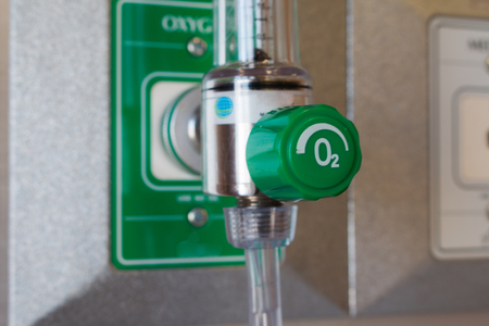 medical oxygen,Close-up image of a medical oxygen mask and valve setting blurry on wallの写真素材