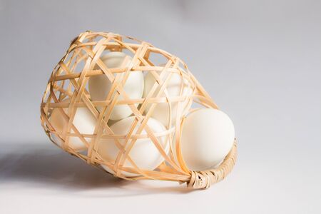 egg in basket wicker on white background,Duck eggs in baskets .の写真素材