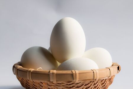 egg in basket wicker on white background,Duck eggs in baskets .の写真素材