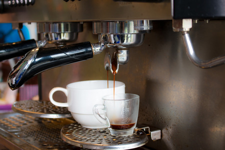 coffee machine preparing fresh coffee and pouring  in cupの写真素材