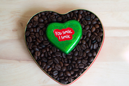 Coffee beans surrounded Chocolate wrapper on Valentine's Day, Wood background.の写真素材