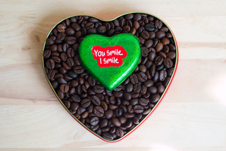 Coffee beans surrounded Chocolate wrapper on Valentine's Day, Wood background.の写真素材