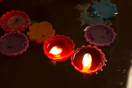 Group of burning candles on the water.の写真素材