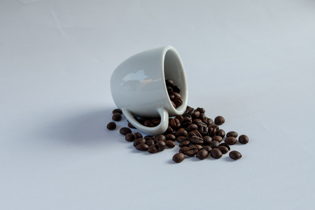 Coffee beans in coffee cup white backgroundの写真素材