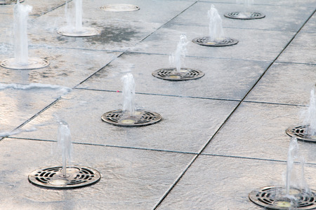 water splashes, in fountain. Summer in the cityの写真素材