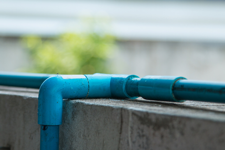 water pvc pipes on cement wallの写真素材
