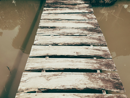 Old wooden bridge across the water.の写真素材