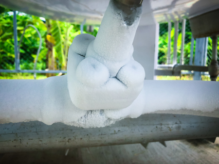 Close up of container with liquid nitrogen,Cold metal pipe smoking from transferring liquid nitrogenの写真素材