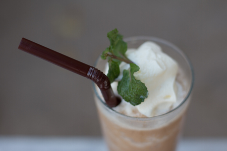Latte mixed with whipped cream , clipping path. Ice coffee blender in a  glass.の写真素材