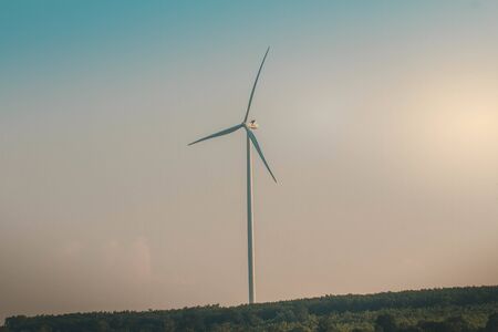 Wind turbines on land field with  sky background