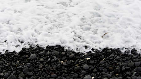 black beach white pebbleの写真素材