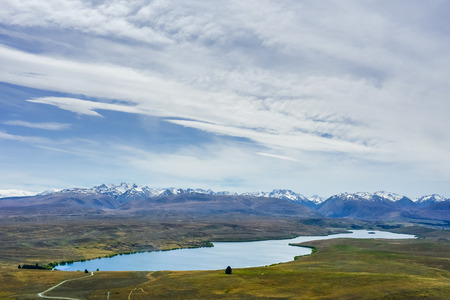 lake in field with mountains backgroundの写真素材
