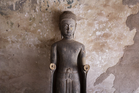 old wooden Buddha in the Laos templeのeditorial素材