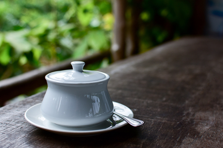 Brow sugar in white ceramic bowl on wood backgroundの写真素材