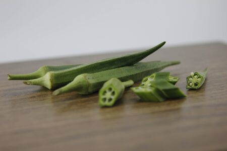 Okra Place on a patterned wooden floor tile.の写真素材