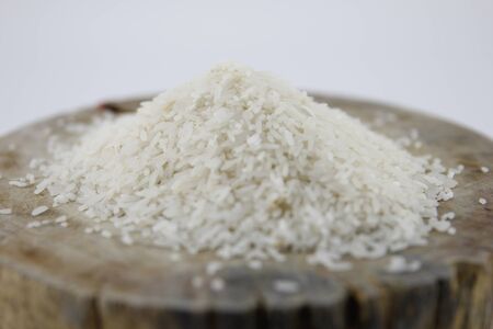 Milled rice on the wood cutting board.の写真素材