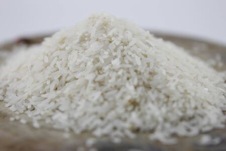 Milled rice on the wood cutting board.の写真素材