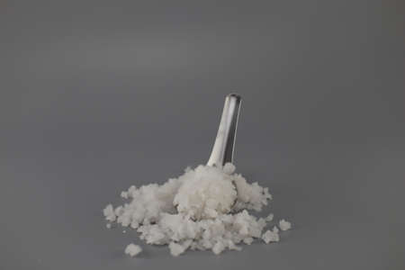 Salt, put in a spoon Located on a gray backgroundの写真素材
