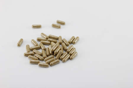 Herbal capsules Placed on a white background.