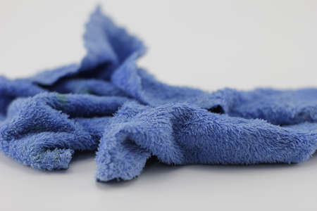 Blue towels laid on a white background.の写真素材