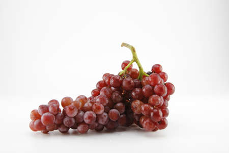 Red grapes on a white background.の写真素材