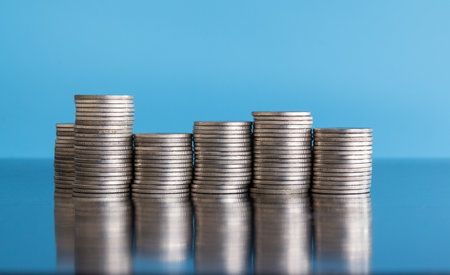 Stacks of coins on blue background, business and finance concept.の写真素材