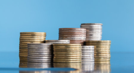 Stacks of coins on blue background, business and finance concept.の写真素材