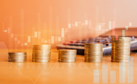 Double exposure of coins stacks with calculator and financial graph on wooden table, business and investment conceptの写真素材