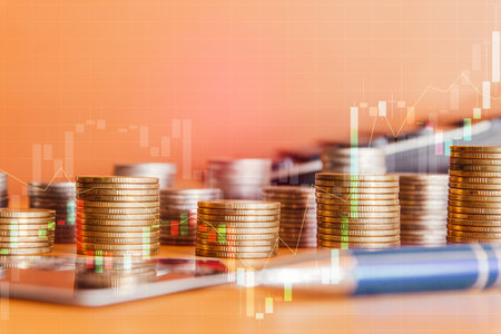 Double exposure of coin stack with stock market graph and tablet for financial and investment conceptの写真素材