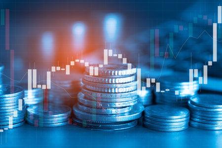 Double exposure of coin stack with stock market or forex trading graph and candlestick chart suitable for financial investment concept.の写真素材