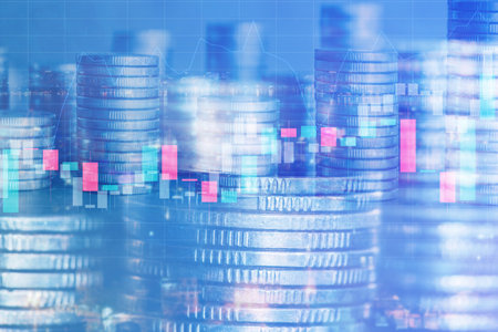Double exposure of coin stack and stock market graph on LED background.の写真素材