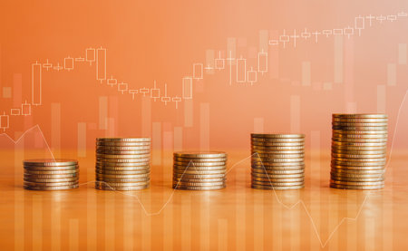 Stacks of coins with stock market or forex trading graph background.の写真素材