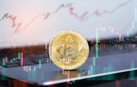 Golden bitcoin coin on the background of the stock exchange. Cryptocurrency concept.の写真素材