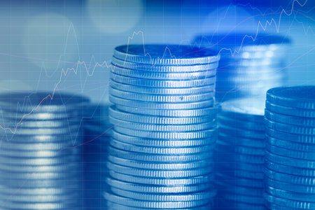 Stacks of coins with forex chart background, business and finance concept idea.の写真素材