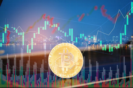 golden bitcoin on the background of the city and the financial chartの写真素材