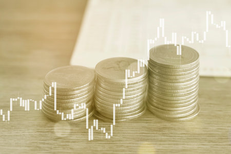 Double exposure of coin stack with stock market or forex trading graph and candlestick chart suitable for financial investment concept.の写真素材