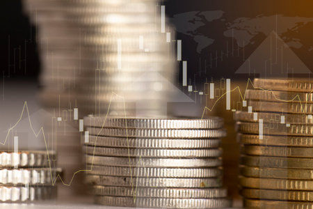 Double exposure of coins stack and graph stock market or forex trading graph and candlestick chart suitable for financial investment concept.の写真素材