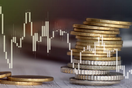 Double exposure of coin stack with stock market or forex trading graph and candlestick chart suitable for financial investment concept.の写真素材