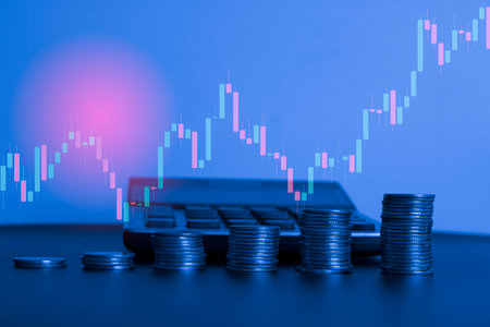 Stacks of coins with stock market or forex trading graph and candlestick chart suitable for financial investment concept.の写真素材