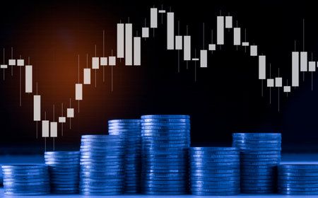 Double exposure of coin stack with stock market graph and candlestick chart for financial investment concept idea.の写真素材