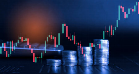 Stacks of coins with stock market graph background, business and finance conceptの写真素材