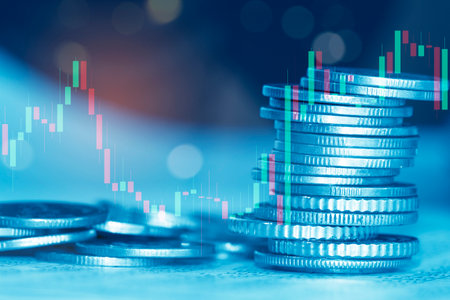 Stacks of coins with candle stick graph chart. Financial and business concept.の写真素材