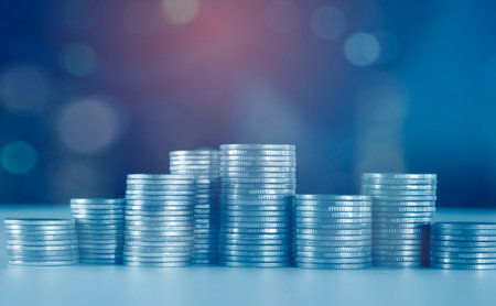Coins stacked on each other with bokeh background, business and finance concept idea.の写真素材