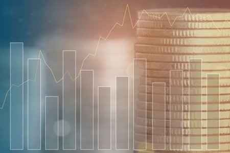 Double exposure of coin stack and financial graph on blurred city background, business and finance concept idea.の写真素材