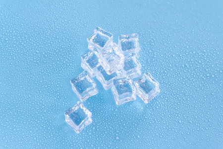 Ice cubes on blue background. Top view. Copy space for text.の写真素材