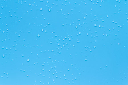 Water drops on blue background. Rain drops on blue glass. Water drops on blue background.の写真素材